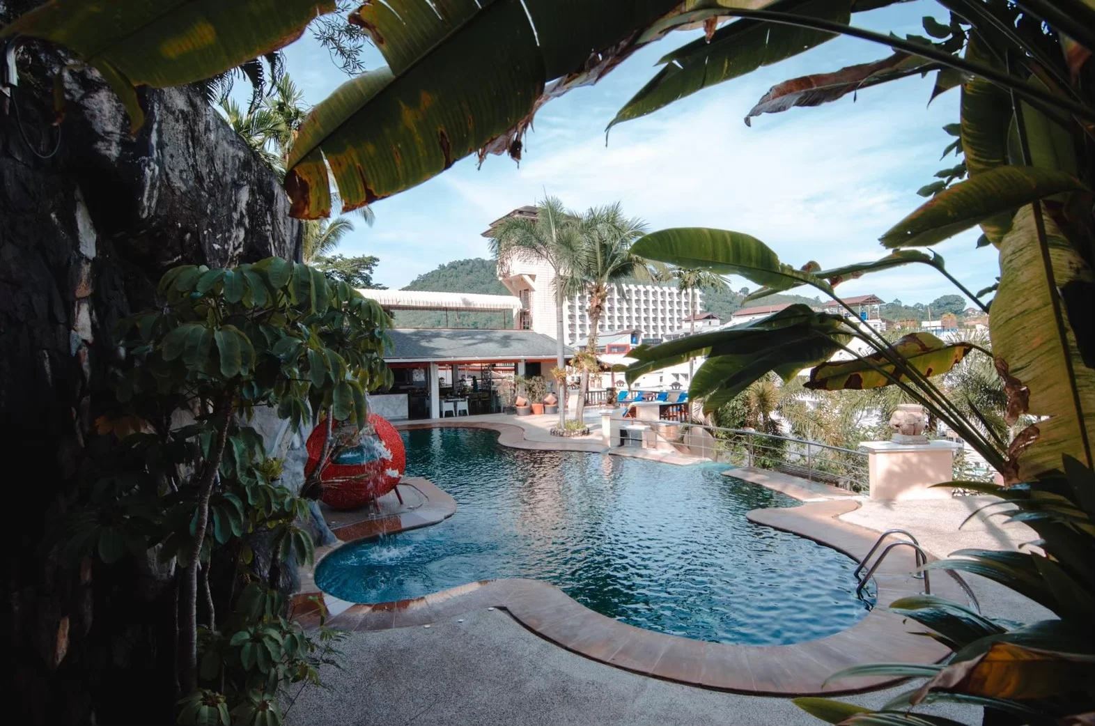 Tropical greenery surrounds the C&N resort swimming pool
